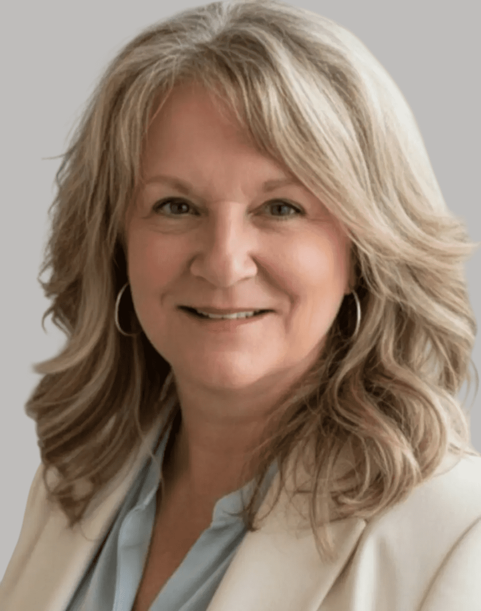 Portrait of a smiling middle-aged woman with blonde hair.